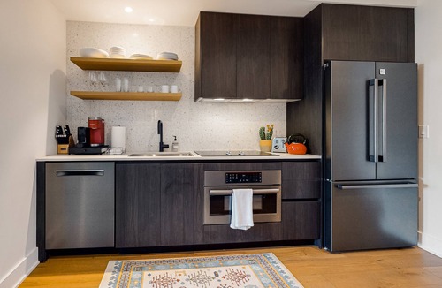 Rainey Street Historic District Apartment | Austin studio condo with WiFi, balcony, W/D, full kitchen, rooftop pool, & gym
