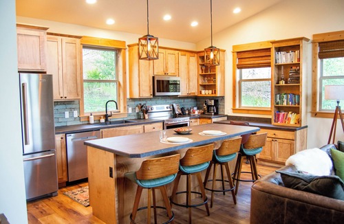 Emigrant House | Backroad Cabin cozy, private retreat, fireplace, backyard with fire pit and string lights.
