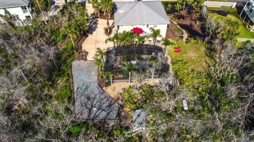 Marineland Acres House | Beach Home with Amazing Oasis Pool Spa Waterfall Fire Pit Bikes