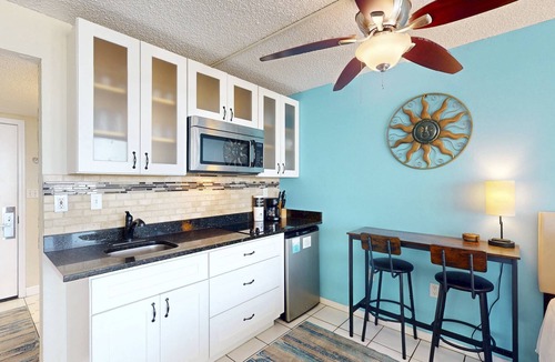 Treasure Island Condo | Beachfront Balcony ~ View of Treasure Island Beach ~ Heated Pool, Tiki Bar, BBQ Grills, Volleyball.