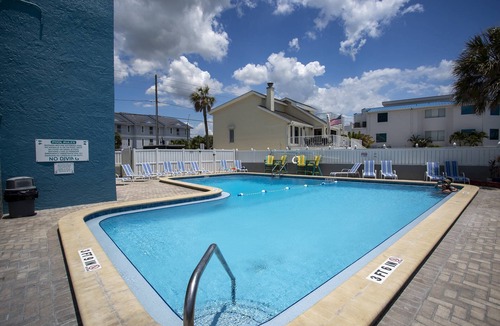 Treasure Island Condo | Beachfront Balcony ~ View of Treasure Island Beach ~ Heated Pool, Tiki Bar, BBQ Grills, Volleyball.