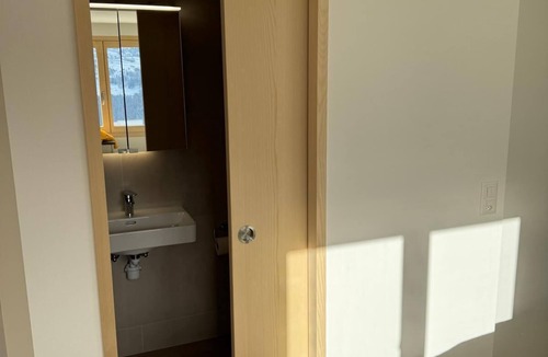 Andiast Apartment | Beautiful, modern studio with underfloor heating, kitchen, shower/WC and seating area.