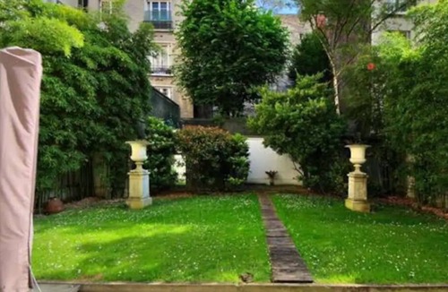 Neuilly-sur-Seine House | Bedroom and small study on veranda overlooking quiet garden