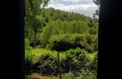 Belle-Isle-en-Terre House | Bow Top Wagon on forest edge