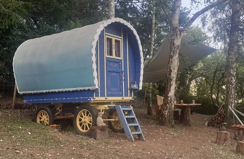 Belle-Isle-en-Terre House | Bow Top Wagon on forest edge