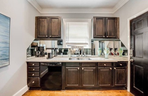 Old East Dallas Condo | Bright 1-bedroom condo combining historic charm with modern comfort. Features a spacious living area with elegant furnishings, crystal lighting, and abundant natural light for a refined Dallas stay.