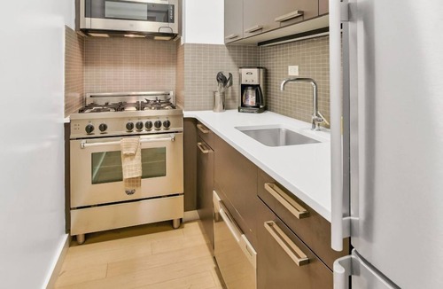 Tudor City Condo | Bright 1BR at The Nash with Roof Deck