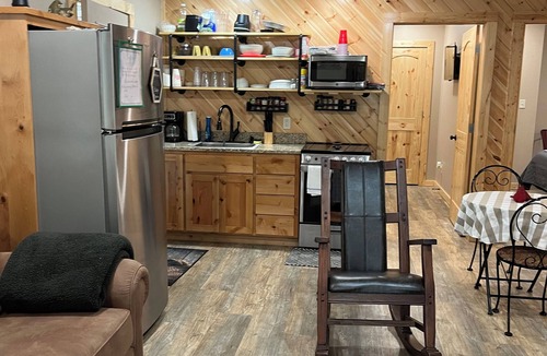 Carlisle Cabin | Cabin Bunkhouse with Hot Tub on Private Lake, Fire Pit & Swings in Vian, OK!