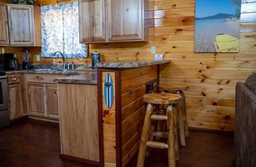 Gepp Cabin | Cabin featuring a vaulted ceiling, a large porch, and huge patio with fire pit.