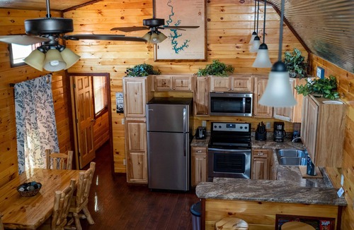 Gepp Cabin | Cabin featuring a vaulted ceiling, a large porch, and huge patio with fire pit.