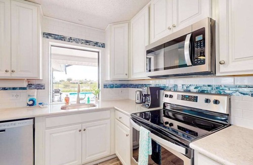Pebble Beach House | Canal-front home with private pool, grill, patio, AC, W/D & gorgeous views