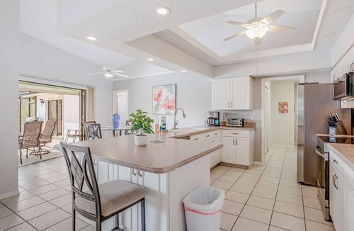 Pebble Beach House | Canal-front home with sandy beaches, golf courses, dock, & refreshing pool