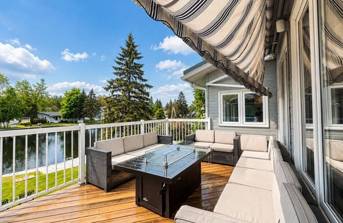 Lagoon City Cottage | Canalside summer cottage w/river views, fire table & outdoor cushioned seating