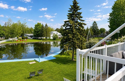 Lagoon City Cottage | Canalside summer cottage w/river views, fire table & outdoor cushioned seating