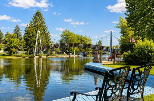 Lagoon City House | Canalside Summer Cottage with Waterview, Custom Bar, BBQ, and Fireplace