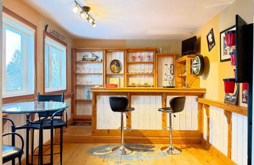 Lagoon City House | Canalside Summer Cottage with Waterview, Custom Bar, BBQ, and Fireplace