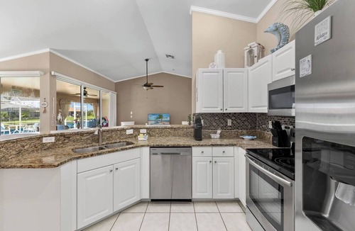 Trafalgar House | Cape Coral Canalfront Oasis: Private Dock, Heated Pool & Arcade Fun