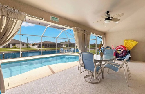 Trafalgar House | Cape Coral Canalfront Oasis: Private Dock, Heated Pool & Arcade Fun