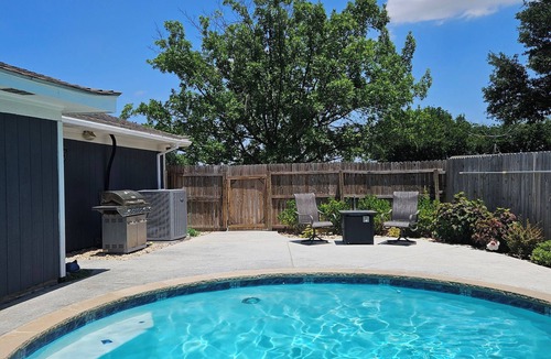 Haltom City House | Central DFW location with cozy fireplace and pool.