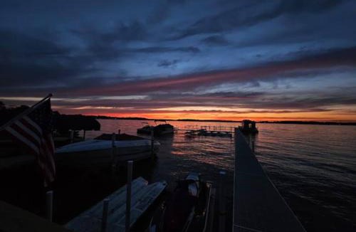 Ingleside Apartment | Chain O' Lakes Beach Penthouse Sunset View and Boat Dock