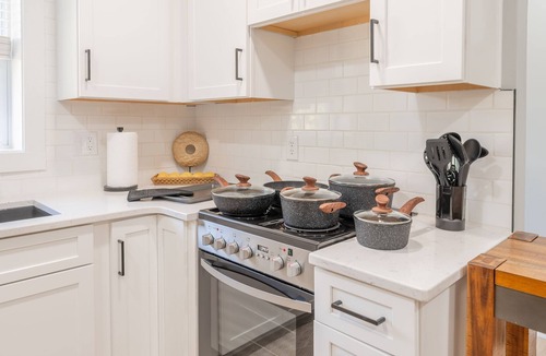 Blacksburg House | Charming cottage entrance with cozy curb appeal, nestled in a peaceful and green setting.