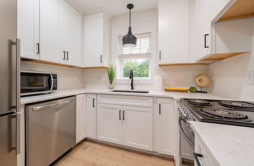 Blacksburg House | Charming cottage entrance with cozy curb appeal, nestled in a peaceful and green setting.