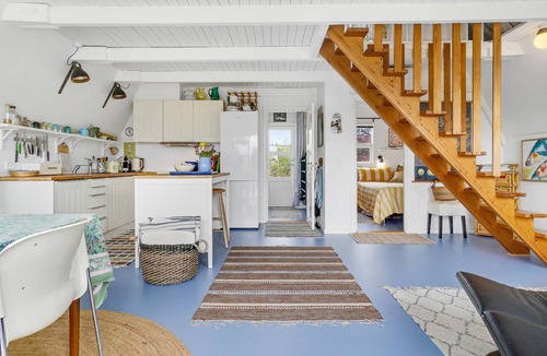 Tørresø House | Charming cottage with fireplace and beautiful view of fields.