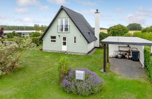 Tørresø House | Charming cottage with fireplace and beautiful view of fields.