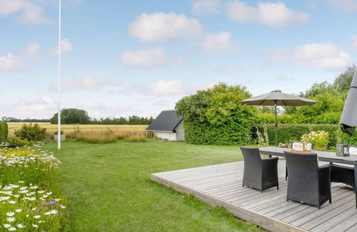 Tørresø House | Charming cottage with fireplace and beautiful view of fields.