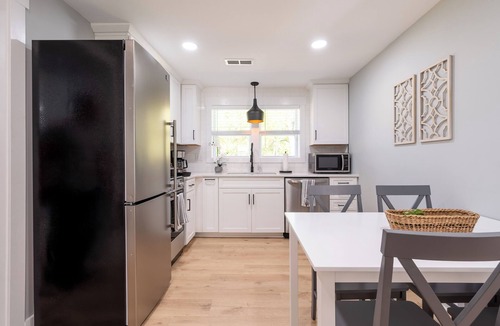 Blacksburg House | Charming entry and spacious back deck surrounded by nature, perfect for a peaceful getaway.
