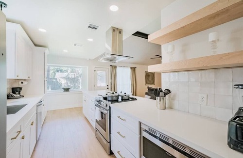 Garden Oaks House | Charming private home sleeps 8 with fenced yard, fast WiFi, smart TVs, large kitchen, and ample parking + 2-car garage—near the Heights & Downtown. Features a primary king ensuite for added privacy.