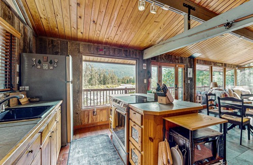 Gold Bar House | Charming riverfront cabin with hot tub, deck, mountain views and W/D