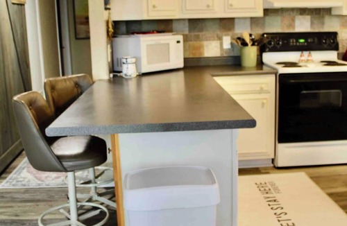 Nocona House | Charming Waterfront Lake Nocona House Cozy 2BR, 2BA lake house with 3 beds + futon on Lake Nocona. Vintage charm meets modern amenities. Enjoy a fully equipped kitchen, multi-level patio with lake views, outdoor seating, grill, and fire pit.