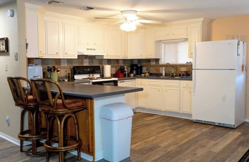Nocona House | Charming Waterfront Lake Nocona House Cozy 2BR, 2BA lake house with 3 beds + futon on Lake Nocona. Vintage charm meets modern amenities. Enjoy a fully equipped kitchen, multi-level patio with lake views, outdoor seating, grill, and fire pit.