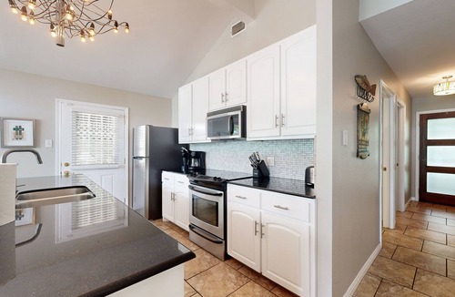 Saratoga Point House | Chic home on Lake Austin with dock, lovely deck, vibrant interior & views