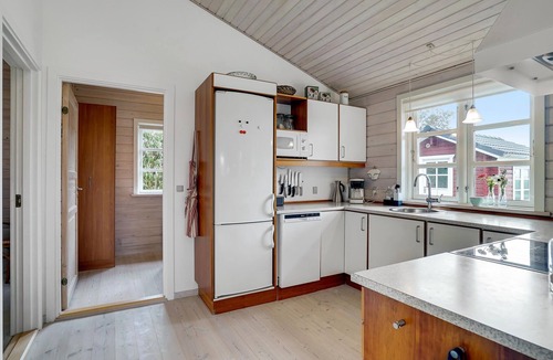 Ertebølle House | Comfortably furnished cottage with kitchen-living room and a fireplace in the living area.