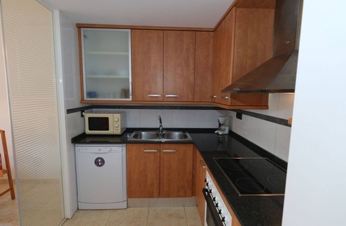 Sant Carles de la Rapita Apartment | Cosy apartment for 3 guests with pool, A/C, TV and balcony