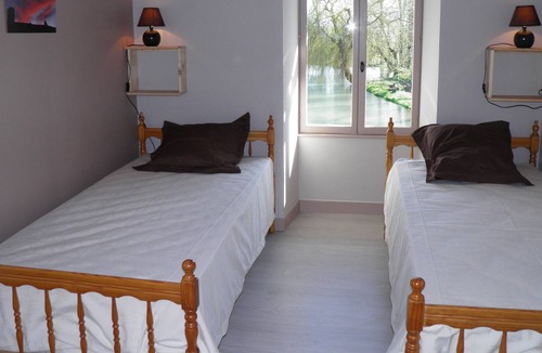 Foussais-Payre House | Cottage adjoining another cottage, with a view of a pond in the Vendée bocage