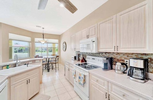 Herons Glen House | Country club retreat with private pool, water views, on-site golf, & gym