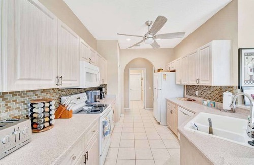 Herons Glen House | Country club retreat with private pool, water views, on-site golf, & gym
