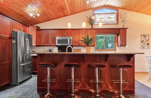 Onanole Cottage | Cozy 3BR Lakefront Retreat Featuring Sauna, Hot Tub, Kayaks