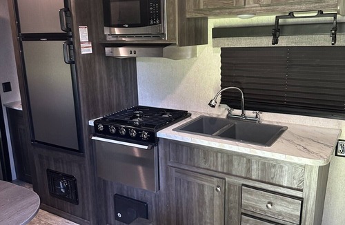 Dawson County House | Cozy camper with queen Murphy bed, bunks, and dinette conversion bed.