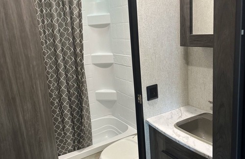 Dawson County House | Cozy camper with queen Murphy bed, bunks, and dinette conversion bed.