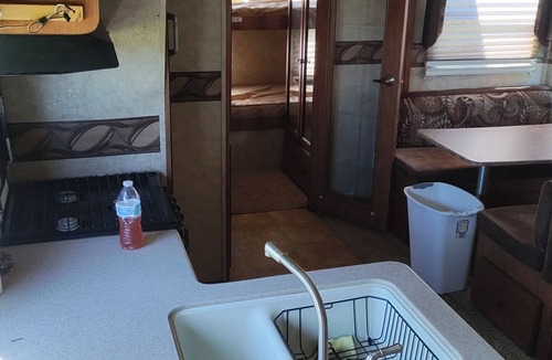 Ragley House | Cozy RV has 2 bedrooms, an outdoor kitchen with a grill & fridge