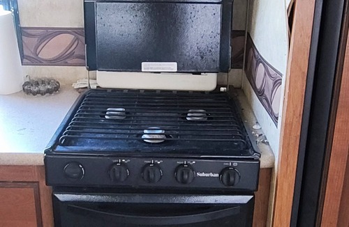 Ragley House | Cozy RV has 2 bedrooms, an outdoor kitchen with a grill & fridge