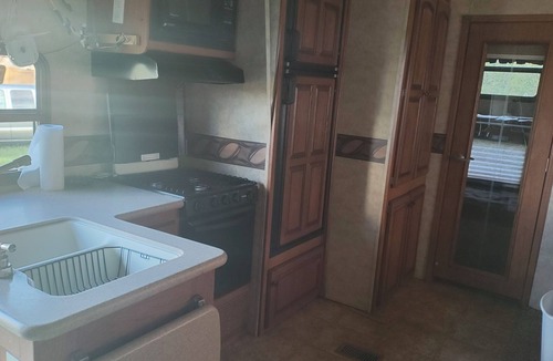 Ragley House | Cozy RV has 2 bedrooms, an outdoor kitchen with a grill & fridge