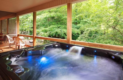 Cosby Cabin | Creekfront cabin with cozy interiors, hot tub & game room.
