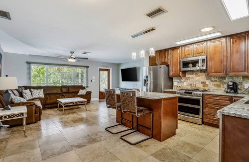 Fort Myers House | Creekside retreat with screened pool, patio, grill, firepit, canoe + kayak, & AC