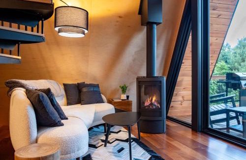 Johnson House | Designer A-Frame Treehouse with hot tub on river