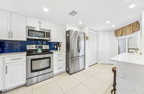 Fernandina Beach Condo | Designer aesthetic with calming sea-foam palette.